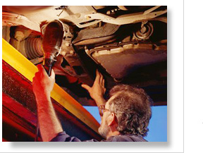 mechanic inspecting overhead car underbody